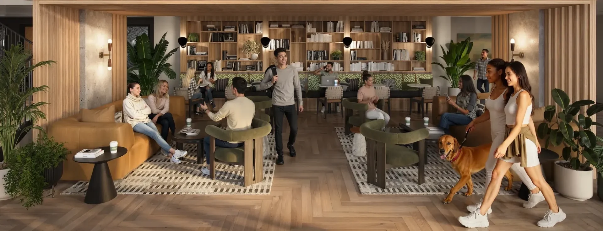 A modern, cozy lounge with people socializing, reading and working. Some sit on sofas and chairs, while a couple walks a dog through the space. The room features bookshelves, plants and warm wood flooring.