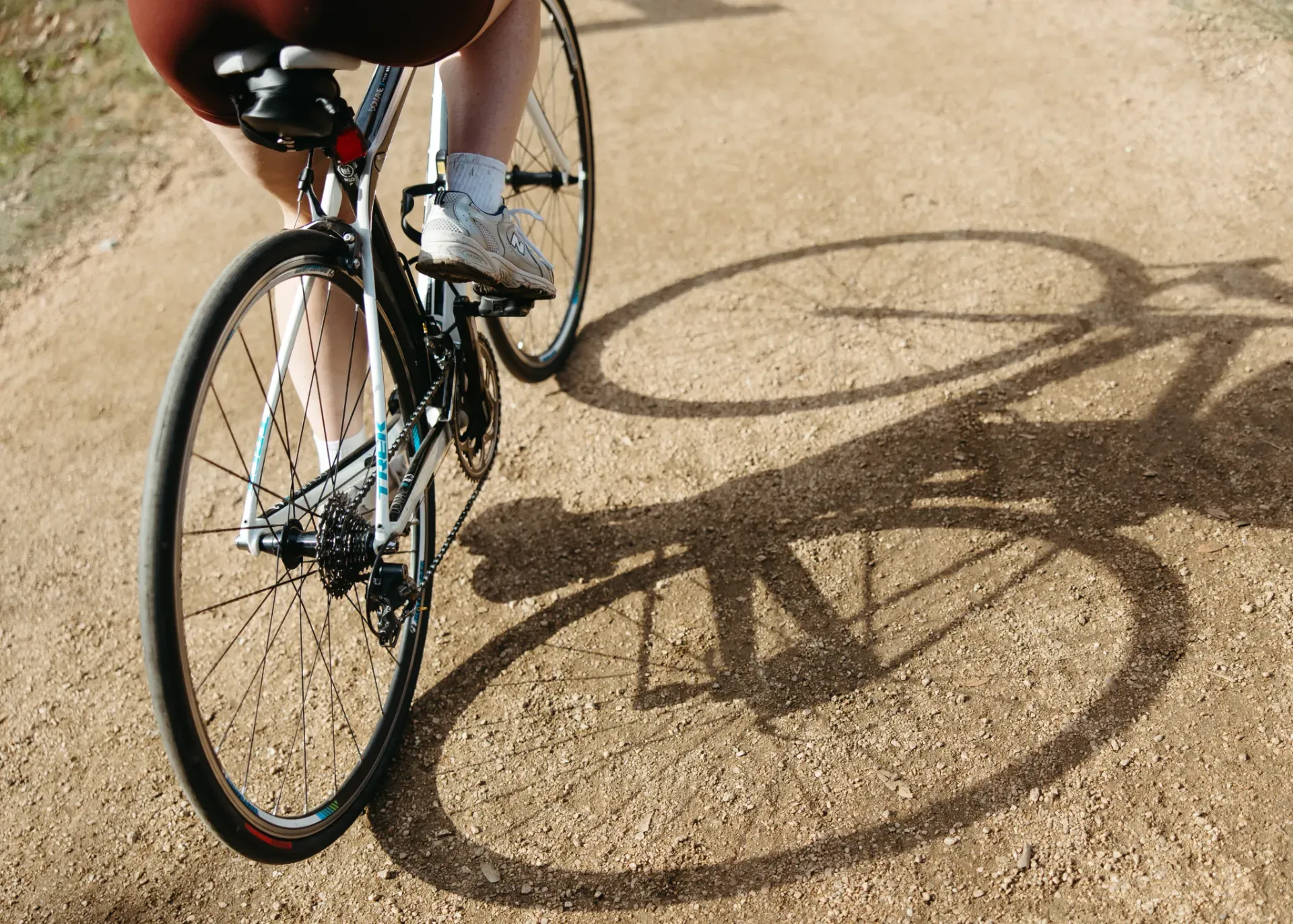 person riding bike on dirt path near University of Maryland