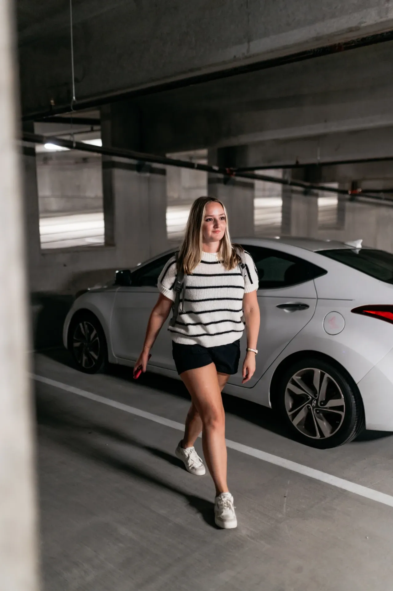University of Maryland student walking from a car in college park parking garage