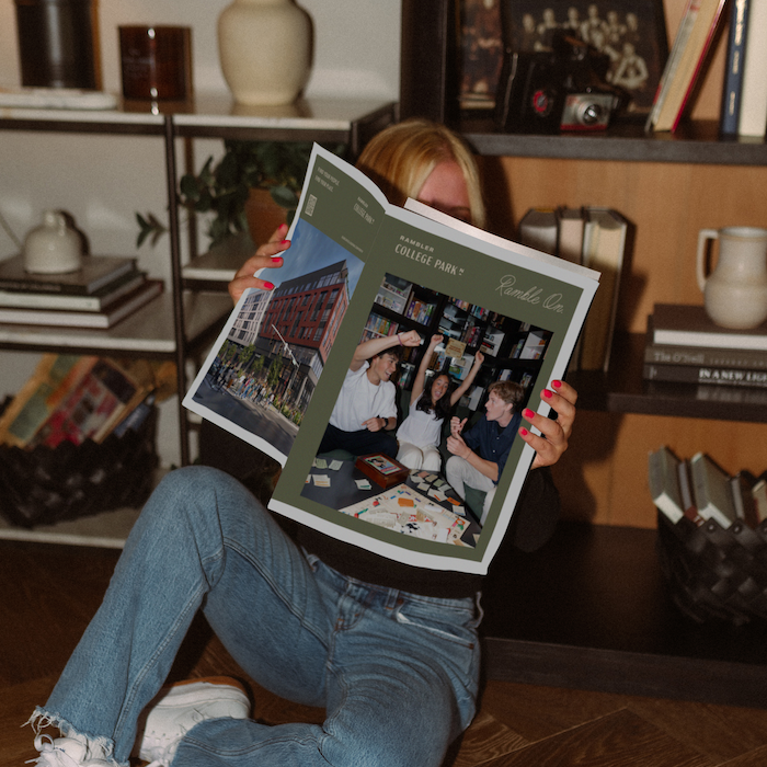 Student reading Rambler College Park North Brochure.
