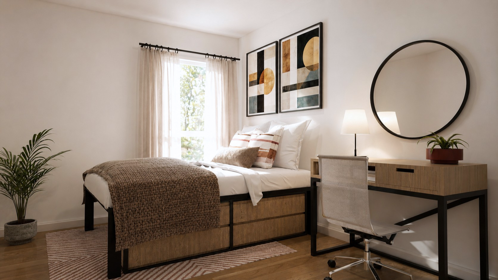 A modern bedroom at Rambler College Park North features a bed with neutral bedding, a desk with a round mirror, a chair, and a lamp. Abstract art adorns the wall, while a plant on the floor brings in touches of greenery. Sunlight filters gently through sheer curtains over the window, creating an inviting and serene atmosphere.
