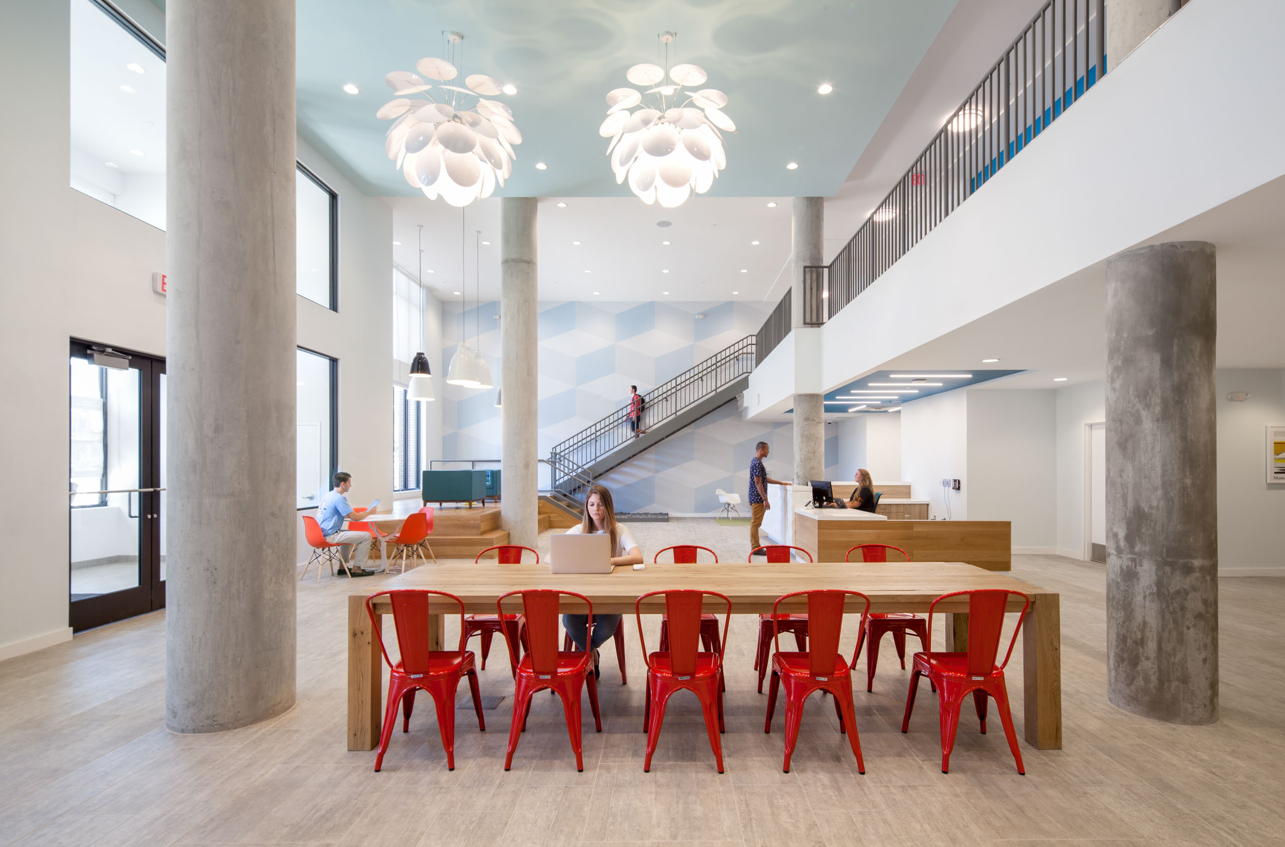 community 14 Rambler College Park South red chairs wood table stairs leading up to corridor tall ceilings front entrance