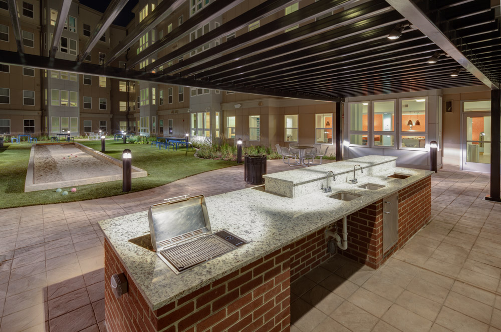 courtyard terrace grilling area sink counter green grass turf landmark college park community 17