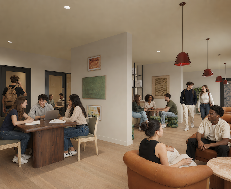 Students sit at tables and lounge in a modern common room at Rambler College Park South, talking, studying, and socializing in small groups. The room has wooden floors, art on the walls, and red hanging lamps.