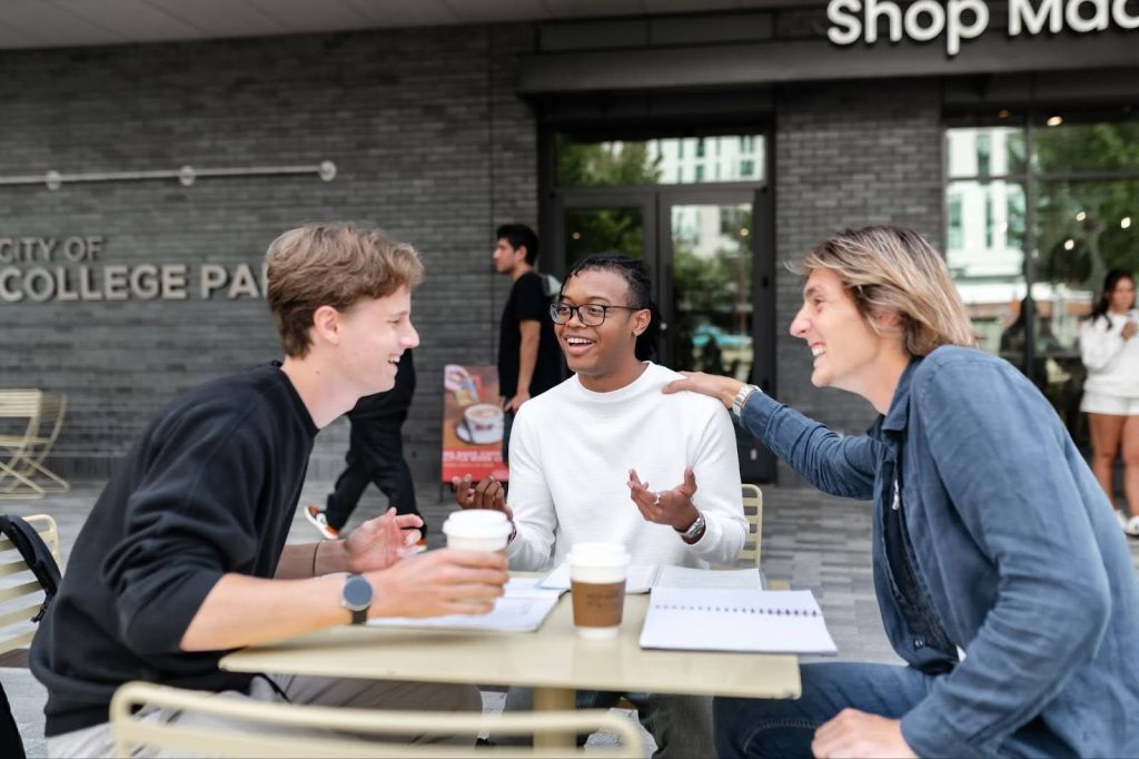 Students work in notebooks on UMD campus.