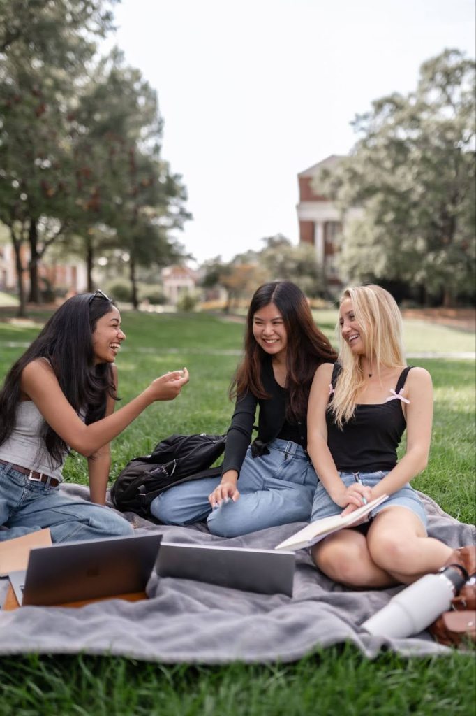 Students sit on the lawn on UMD campus.