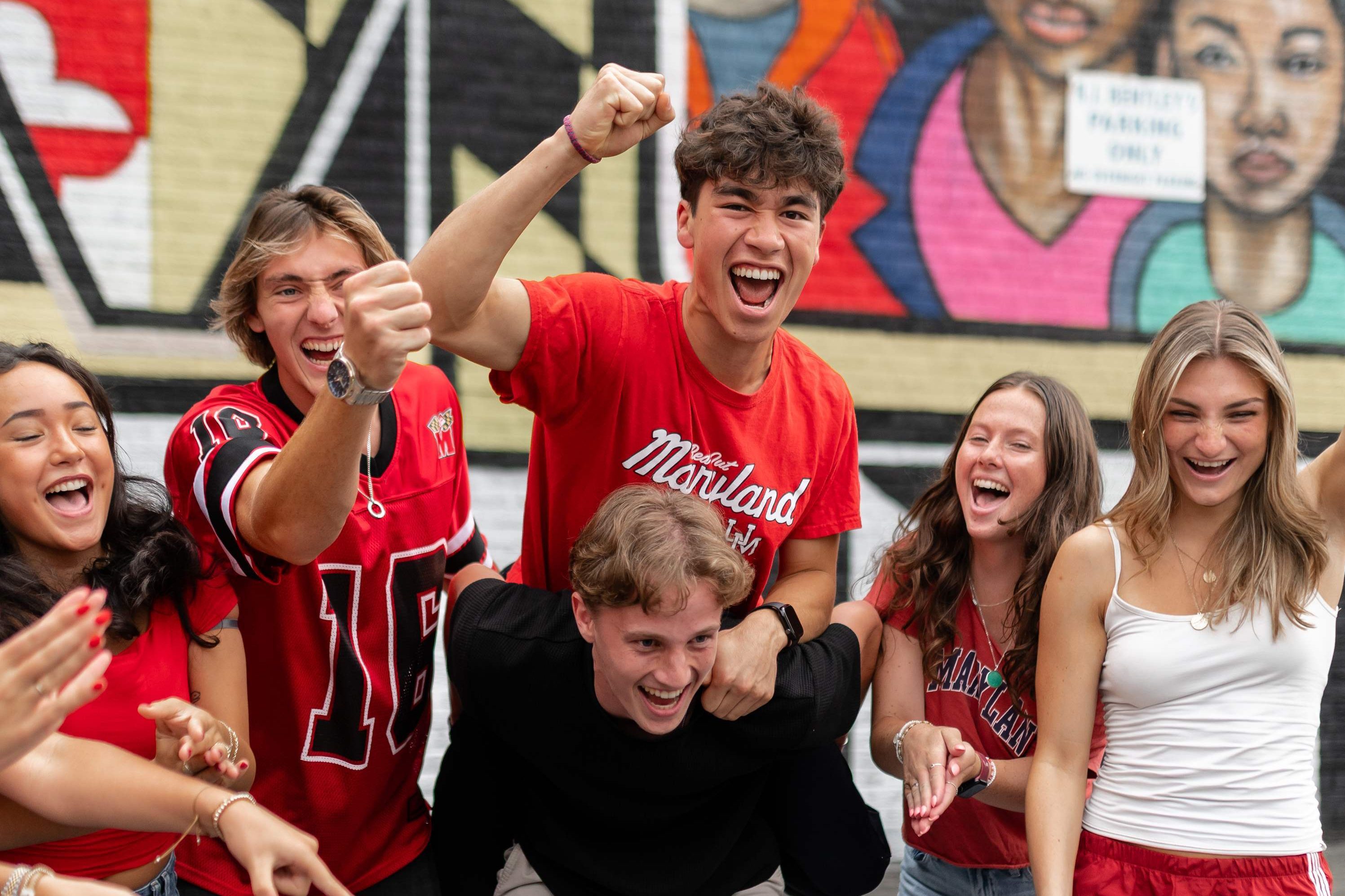 New University of Maryland students laugh outside off campus in College Park.