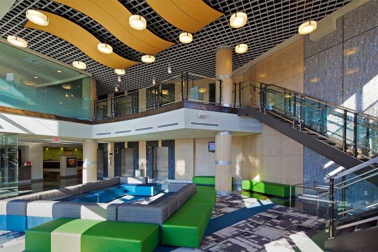 Lobby at The Varsity College Park with a two-story atrium and lounge seating