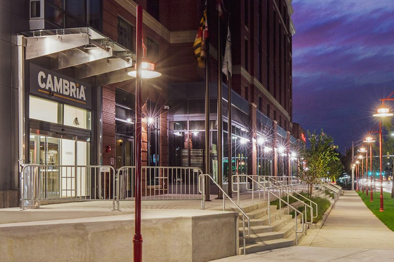 Sidewalk view of Cambria Hotel College Park’s entrance.
