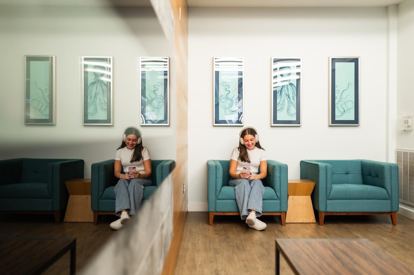 Student listening to music in a traditional student apartment near UMD. 