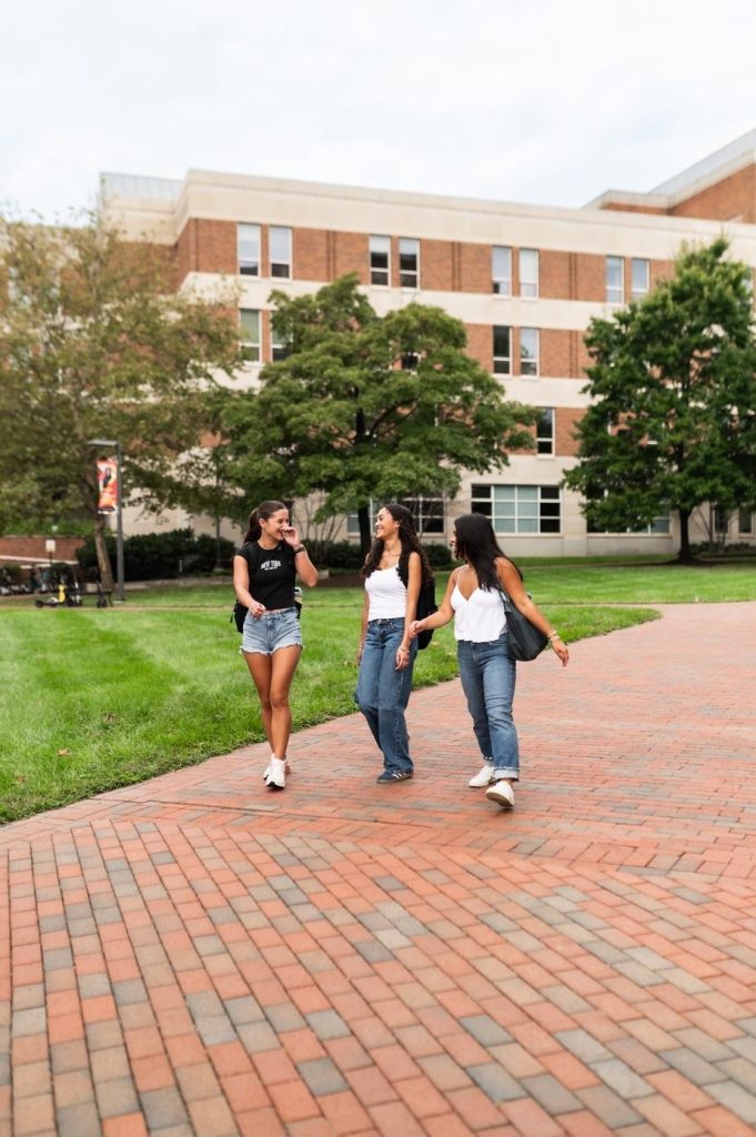 Students walking together on UMD campus, near the Robert H. Smith School of Business.