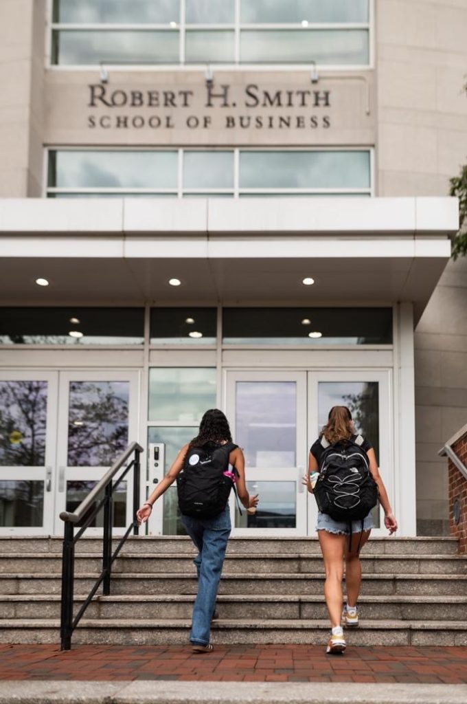 Students walking into Robert H. Smith School of Business.