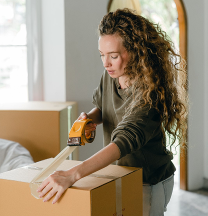 A new resident enters Rambler with their moving boxes in College Park. 