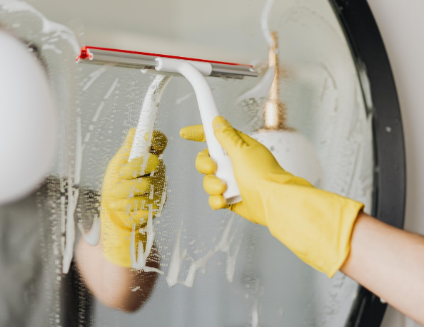 New resident at Rambler College Park cleans the mirror in their unit opening Fall 2027. 