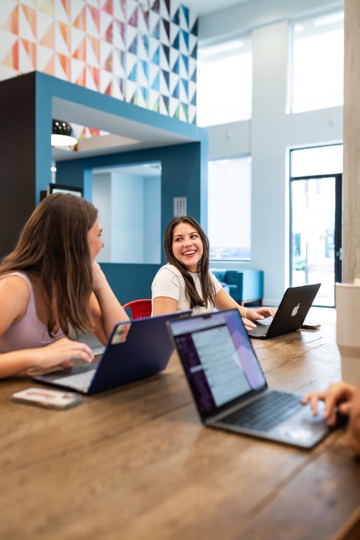 Students studying in a common area in their apartment at UMD. 
