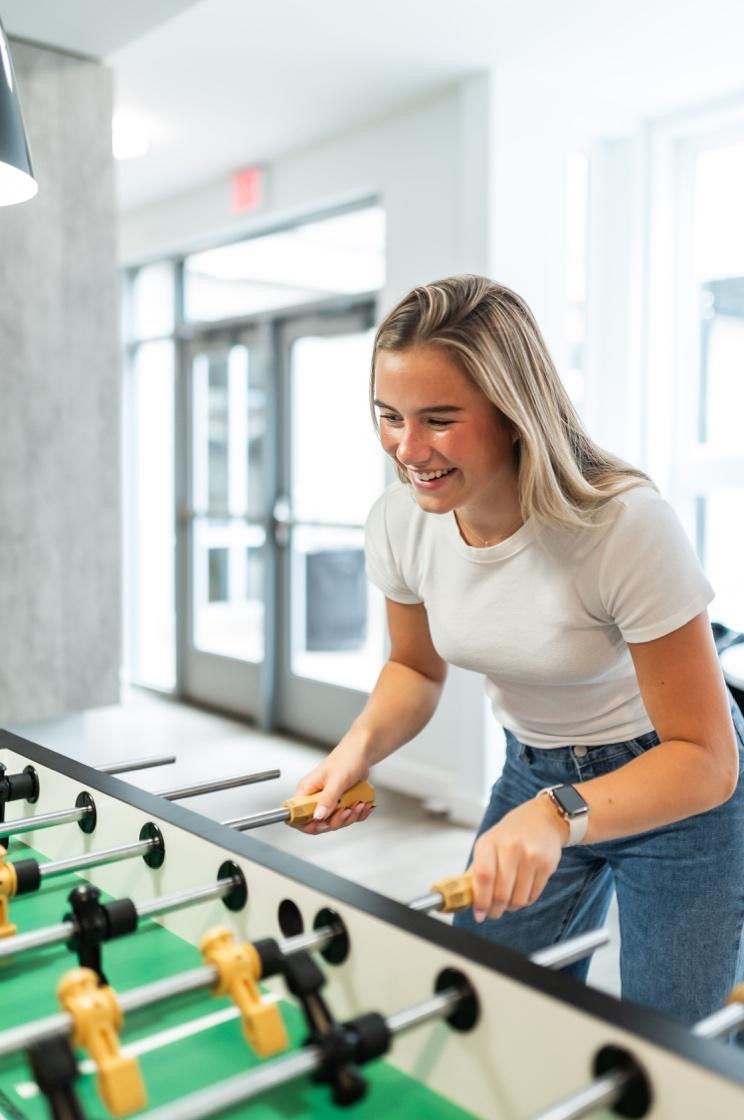 Student using amenities at their off-campus apartment near UMD. 