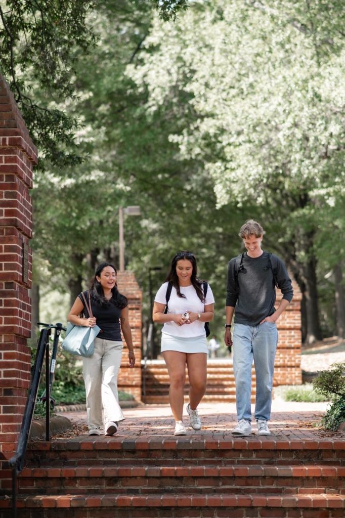 Friends walking to class on UMD campus together. 