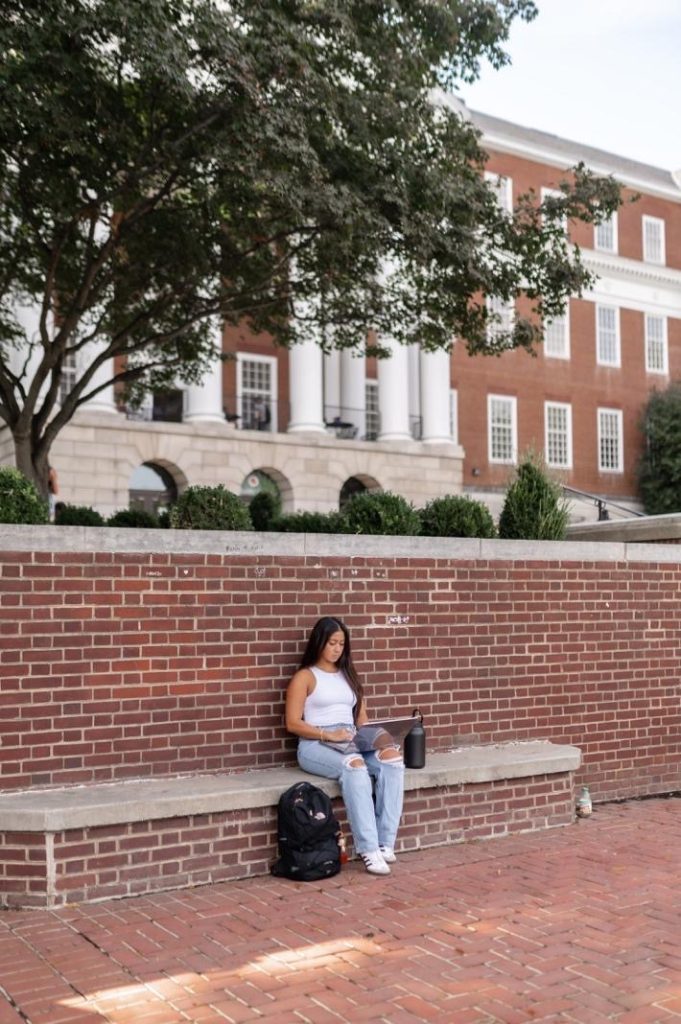 Student outside of McKeldin Library on UMD campus.