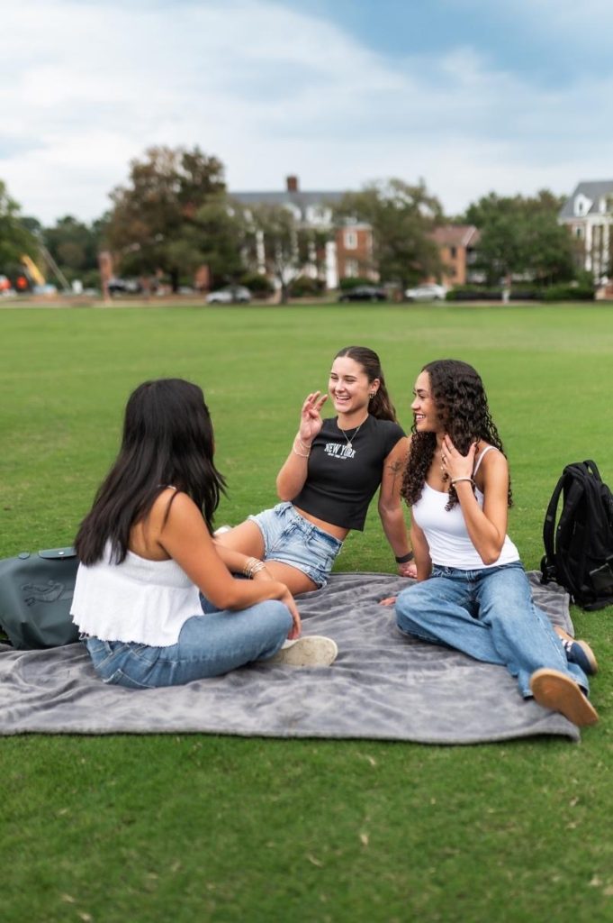 Students outdoors on Fraternity Field on campus.