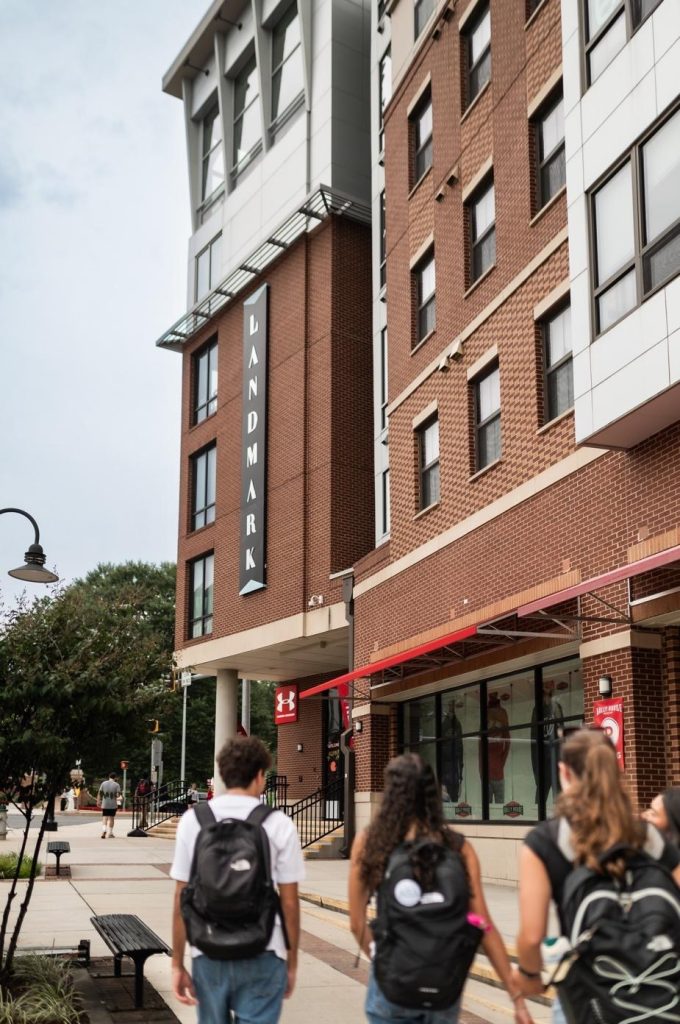 Students walking outside of Rambler College Park South, a student apartment.